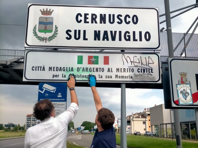 Imbrattati e puliti dagli assessori i cartelli “Cernusco sul Naviglio medaglia d’argento della Resistenza”
